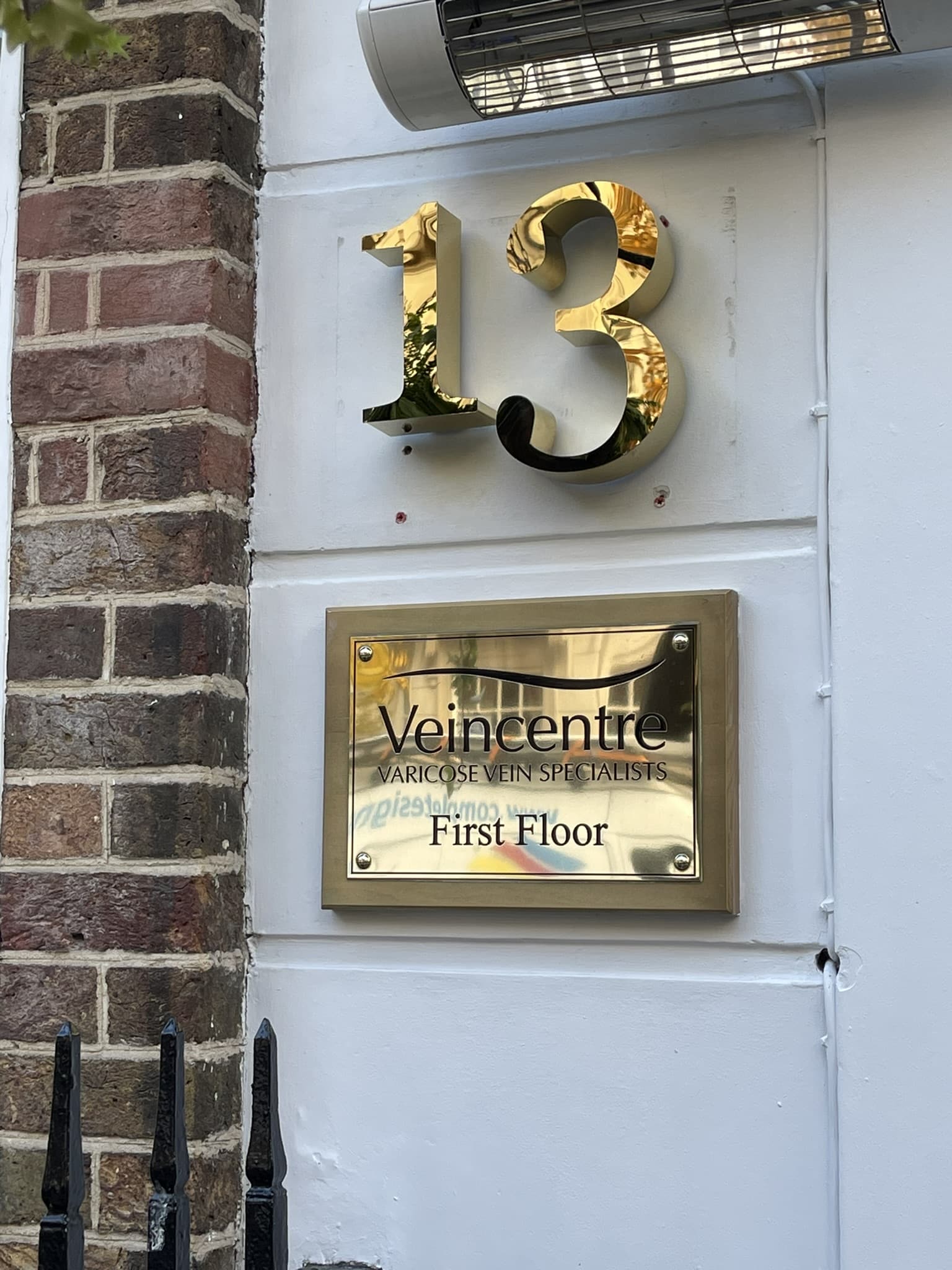 Nameplate Signs - Hero blue awning on high street shop
