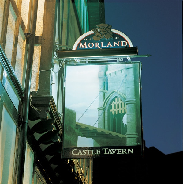 Signage Lighting Solutions - Gallery 25 blue awning on high street shop